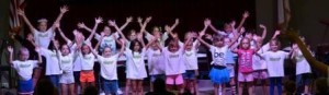 Children at First Baptist Church's school for kids act out a song.