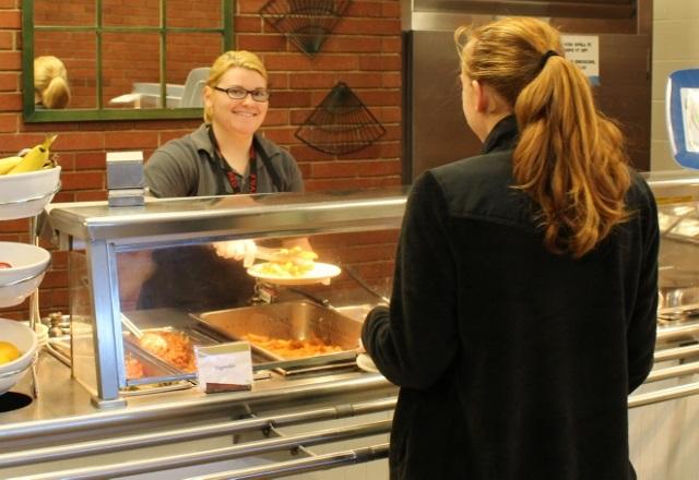 Brisha Jenkins serves up meals at the Allen cafeteria as part of her work study position.