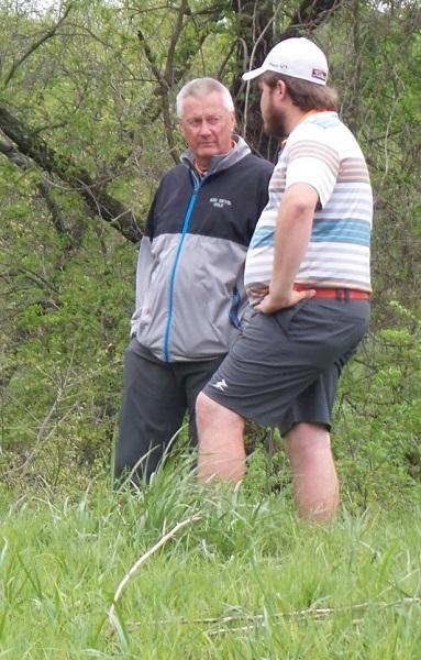 Coach Mike Hayes visits with Allen golfer Drake Dieker during a practice round.