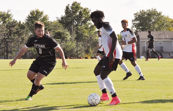 Victor Nwankwo handles the ball against an Ottawa University player in an Allen Red Devils game earlier this season.