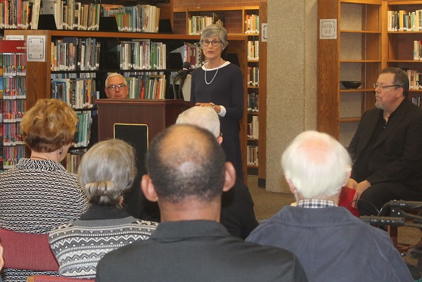 Susan Lynn, editor and publisher of the Iola Register, speaks of her familys involvement in the local newspaper over the past 150 years during a reception and program at the Allen Library. Allen Community College honored the Registers sesquicentennial on Sept. 27. Taking part were Doug Anstaett of the Kansas Press Association, left, Bruce Symes, Allen journalism instructor, right, and Allen President John Masterson.
