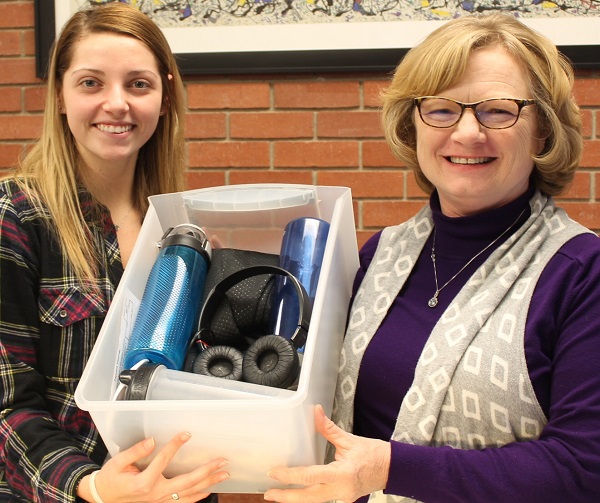 Hannah Hudlin, left, and Becky Leis show the contents of the lost and found box in the administration office.