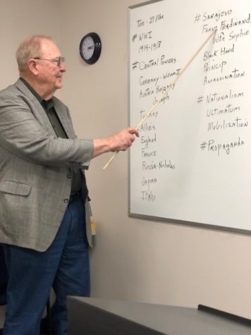 William Shirley stands at his white board as he presents the notes for the day’s class.