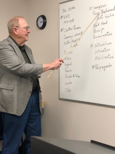 William Shirley stands at his white board as he presents the notes for the day’s class.