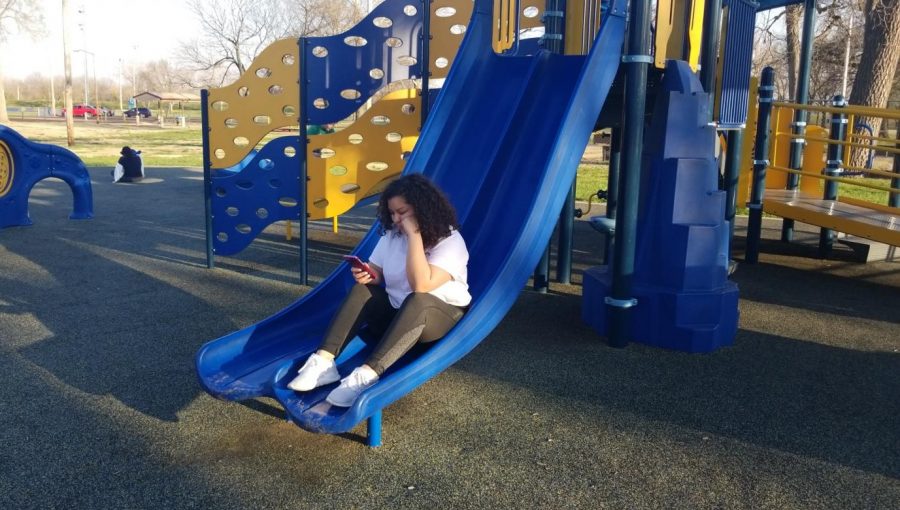 IM SO BORED... LOL. Allen student Cristal Macias helps illustrate the lack of community appreciation in young people at Riverside Park, in Iola, KS.