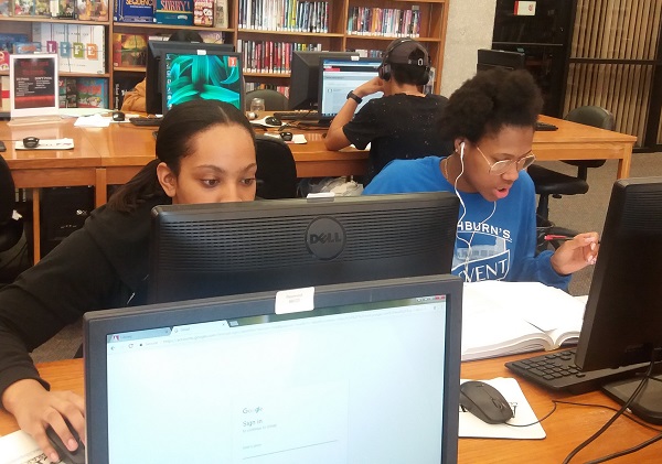 Students use the library computers to access the internet for studies and social media.