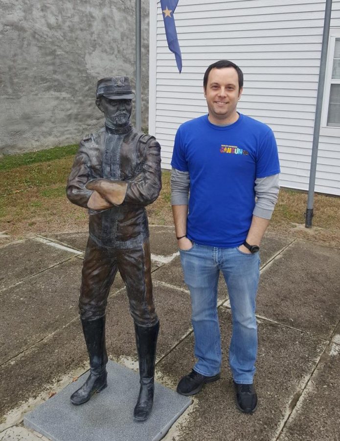 Curator of the Allen County Historical Society Kurtis Russell stands beside the statue of Major General Frederick Funston in downtown Iola, Kan. 