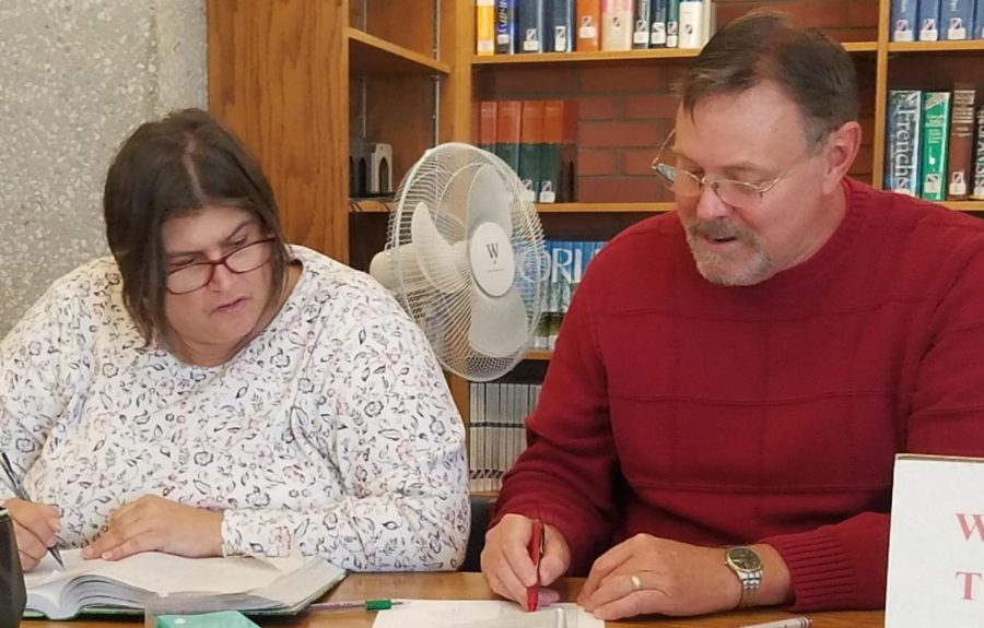 Jerry Vincent, Math Center coordinator for Allen Community College, helps Lisa Burton with an algebra problem in the Academic Support area of the Iola Library.