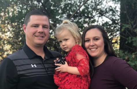Andy and Whitney Shaw, both head coaches at Allen, pose with their two year old daughter, Tatum.