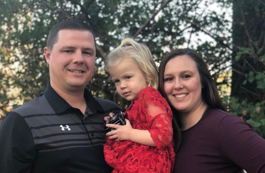 Andy and Whitney Shaw, both head coaches at Allen, pose with their two year old daughter, Tatum.