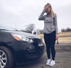 Freshman Brianna Brady lets out a sigh as she looks at her damaged car after a collision in Allen Community Colleges Winter Hall parking lot.
