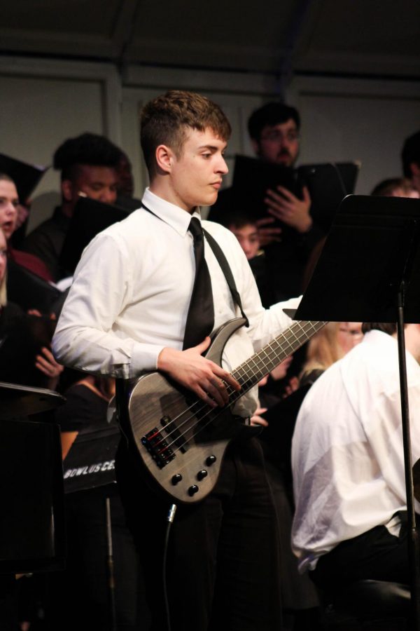 Hunter Crane, who played several instruments throughout the concert, rocked out on the bass guitar during the finale performance of Disney Film Favorites.
