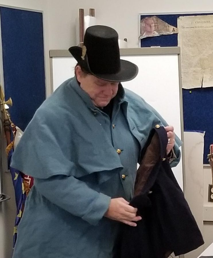Steve Dodson, history instructor at Allen Community College, shows some weapons, uniforms and other gear he’s acquired for Civil War and Revolutionary War re-enactments.
