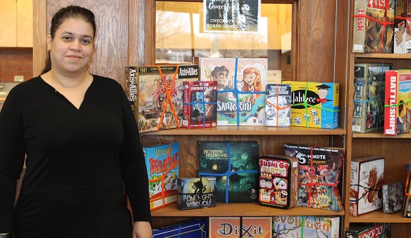 Heather Van Dyne, assistant library director, checks board games out to Allen students.