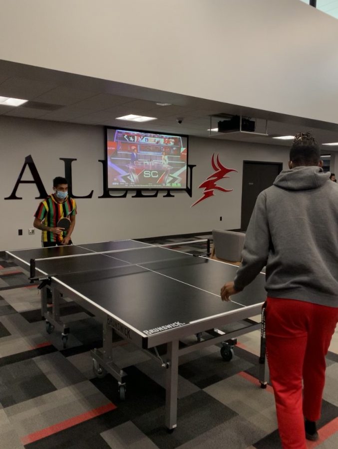 Second-year students Armando Colome and Jelani Heard play ping pong, one of the scheduled Residence Hall Olympic games, in the student center. 