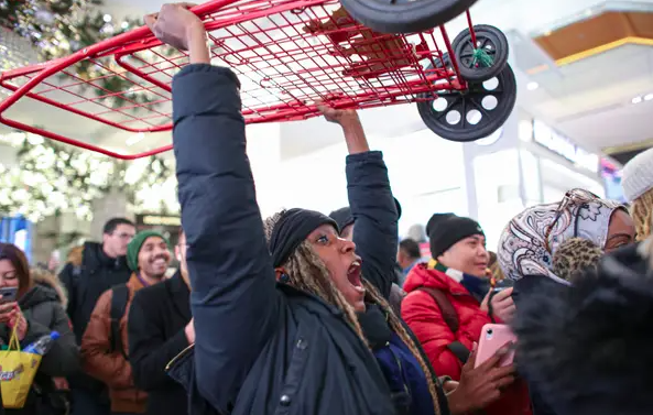 A happy customer celebrates victory over her opponent in the ancient rite of Black Friday Jousting.