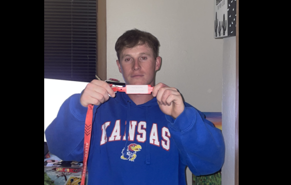 Byrone Okes, a sophomore at Allen Community College, showing off his tag bracelet.